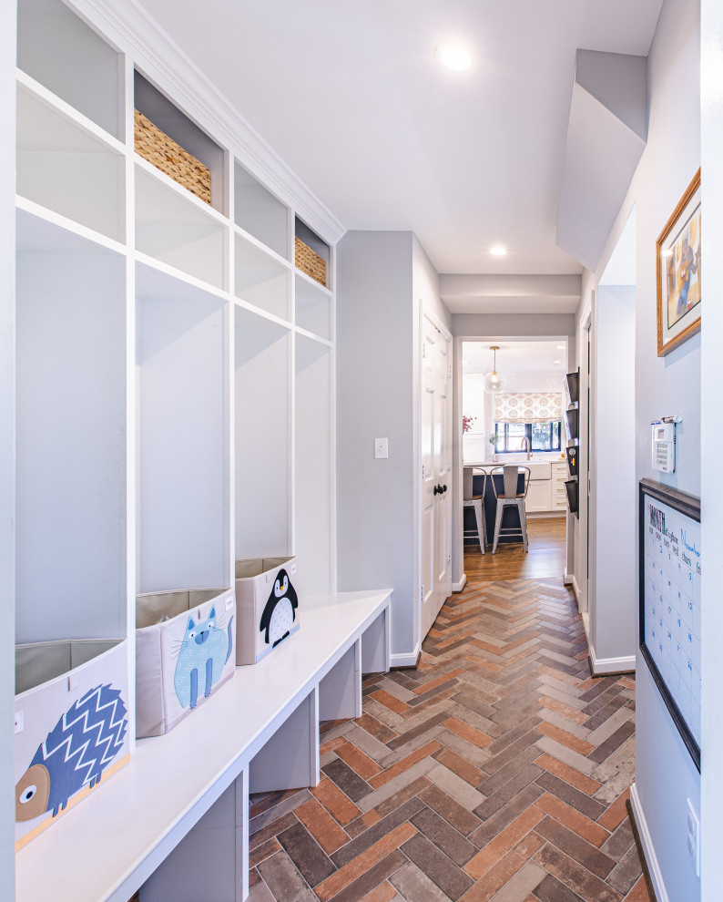 Inspiration for a mid-sized transitional mudroom in DC Metro with grey walls, slate floors and multi-coloured floor.