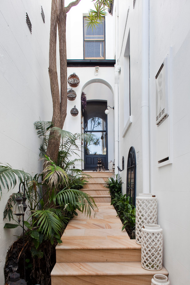 Design ideas for a transitional front door in Sydney with white walls, a single front door and a black front door.