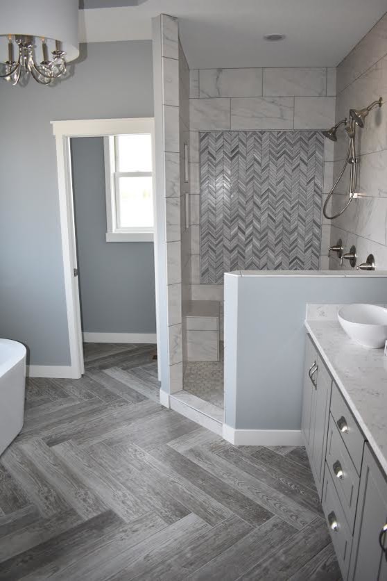 Design ideas for a mid-sized transitional master bathroom in Minneapolis with raised-panel cabinets, grey cabinets, a freestanding tub, an open shower, a two-piece toilet, gray tile, white tile, porcelain tile, grey walls, porcelain floors, a vessel sink, engineered quartz benchtops, grey floor and an open shower.