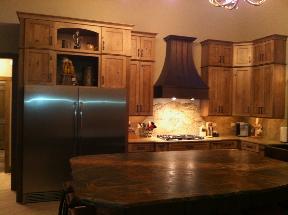Large mountain style l-shaped porcelain tile open concept kitchen photo in Chicago with a farmhouse sink, recessed-panel cabinets, medium tone wood cabinets, granite countertops, beige backsplash, stone slab backsplash, stainless steel appliances and an island