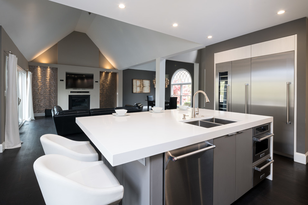 Inspiration for a mid-sized contemporary l-shaped open plan kitchen in Atlanta with an undermount sink, flat-panel cabinets, grey cabinets, quartz benchtops, white splashback, stainless steel appliances, dark hardwood floors, with island, black floor and white benchtop.