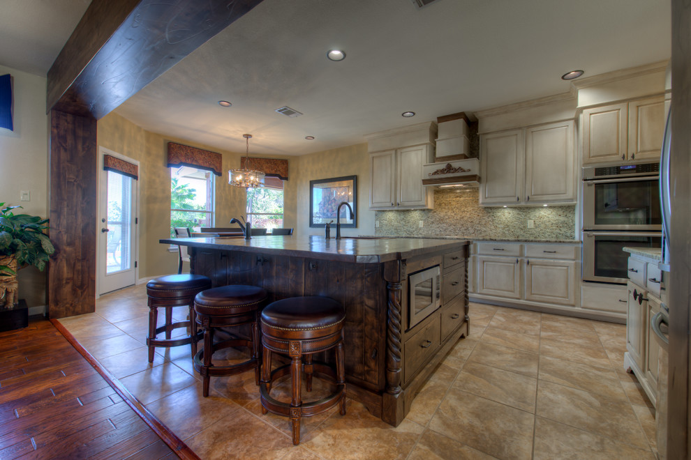 Eat-in kitchen - mid-sized rustic l-shaped eat-in kitchen idea in Austin with a single-bowl sink, wood countertops, stainless steel appliances and an island