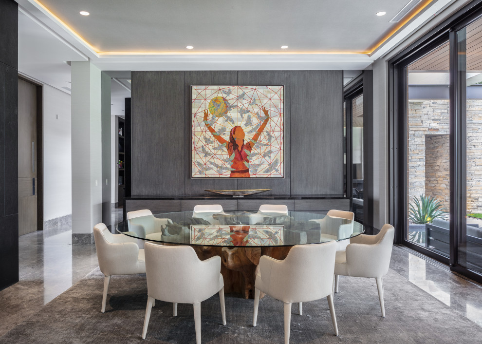 This is an example of a large contemporary dining room in Austin with grey walls and grey floor.