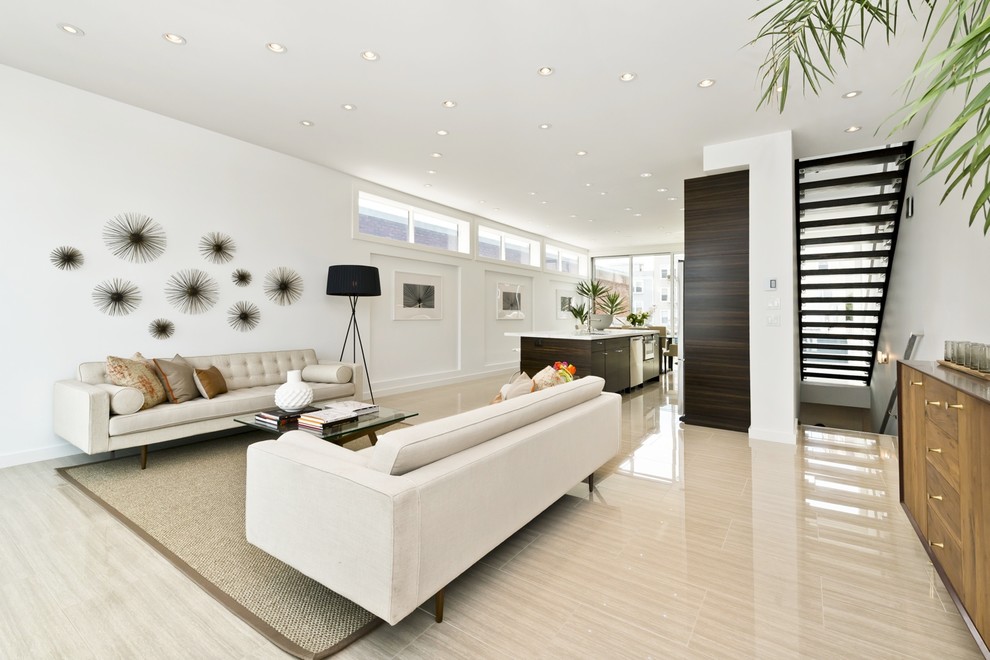 This is an example of a contemporary open concept living room in San Francisco with white walls, no tv and beige floor.