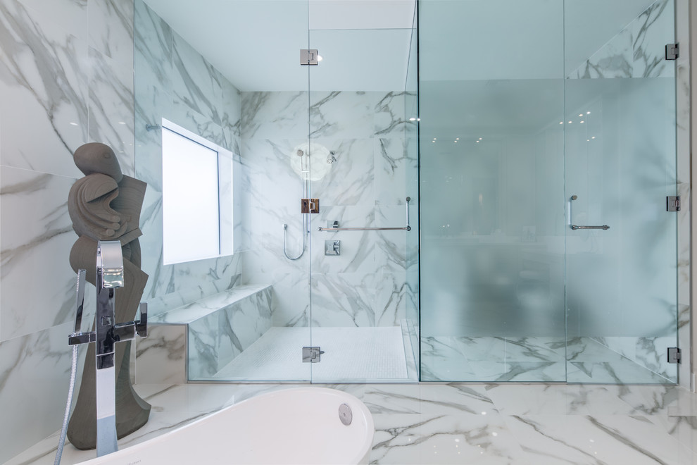 This is an example of an expansive contemporary master bathroom in Miami with a drop-in sink, flat-panel cabinets, grey cabinets, engineered quartz benchtops, a freestanding tub, a curbless shower, white tile, porcelain tile, white walls and porcelain floors.