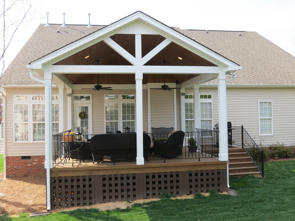 Photo of a mid-sized contemporary backyard deck in Charlotte with a roof extension.