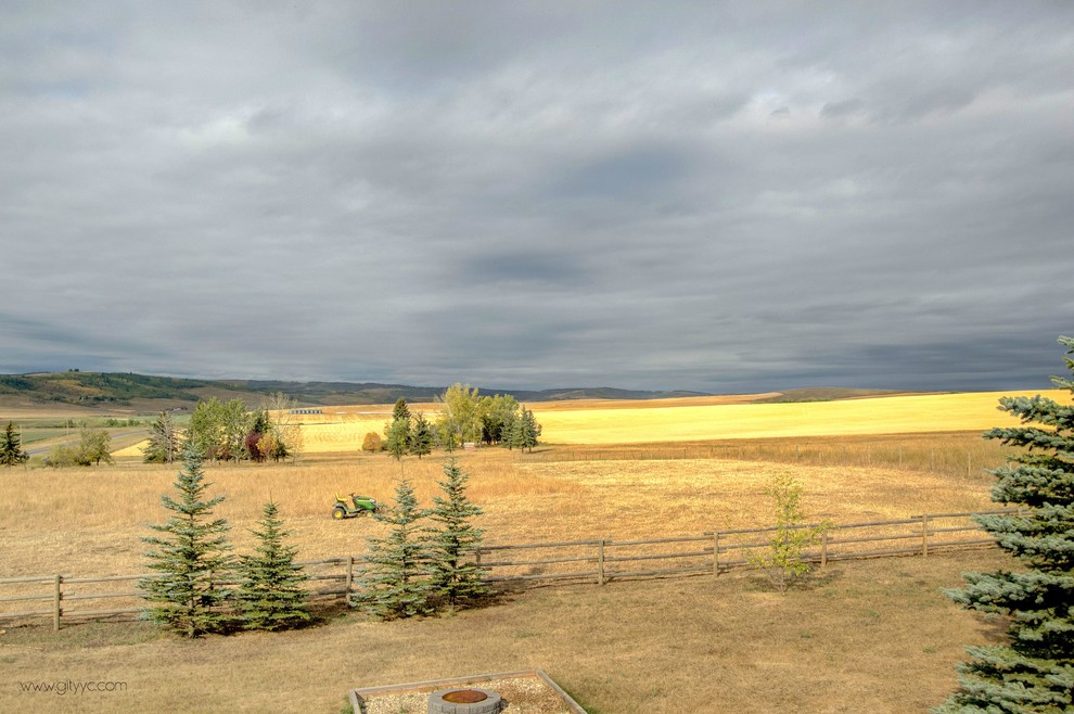 Inspiration for a rustic partial sun backyard landscaping in Calgary.