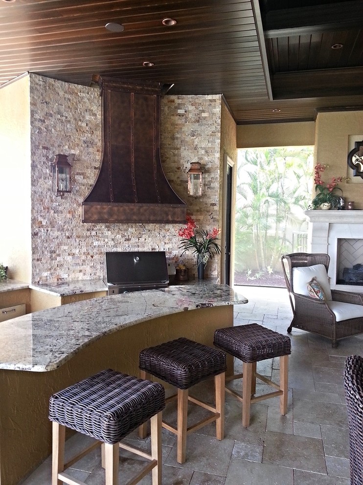 Inspiration for a large country backyard patio in Tampa with an outdoor kitchen, tile and a roof extension.