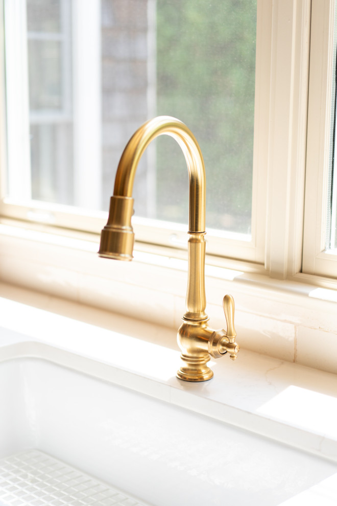 Elegant Golden Kitchen Faucet with Sunlit Background Interior Design