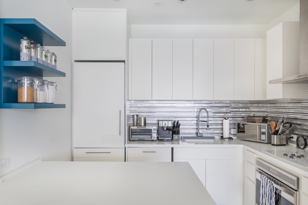 Photo of a small contemporary l-shaped separate kitchen in Miami with an integrated sink, flat-panel cabinets, white cabinets, metallic splashback, metal splashback and a peninsula.