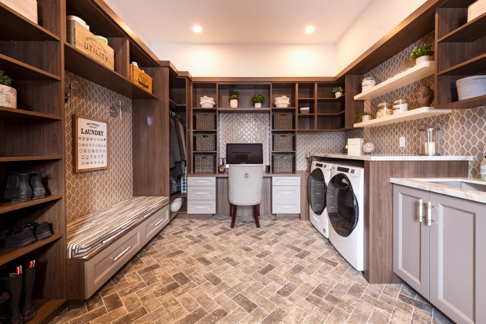 Photo of a large contemporary u-shaped utility room in Toronto with a submerged sink, shaker cabinets, engineered stone countertops and a side by side washer and dryer.