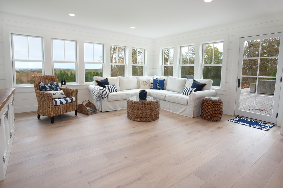 This is an example of a mid-sized beach style sunroom in Boston with light hardwood floors, no fireplace, a standard ceiling and white floor.