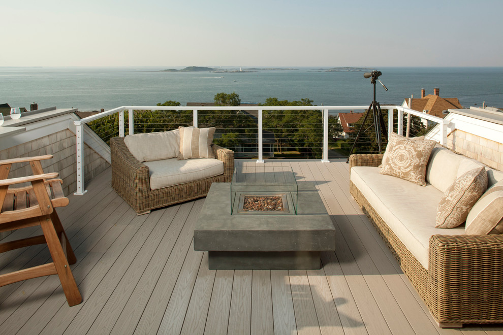 Photo of a beach style rooftop and rooftop deck in Boston with a fire feature.