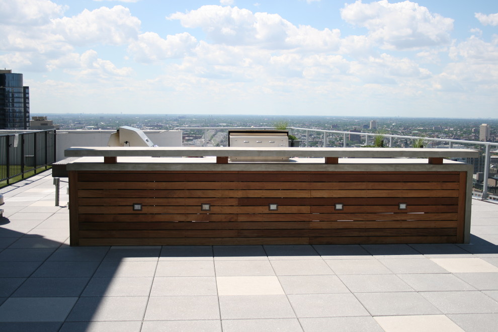 Inspiration for a small contemporary rooftop deck in Chicago with a fire feature and a roof extension.