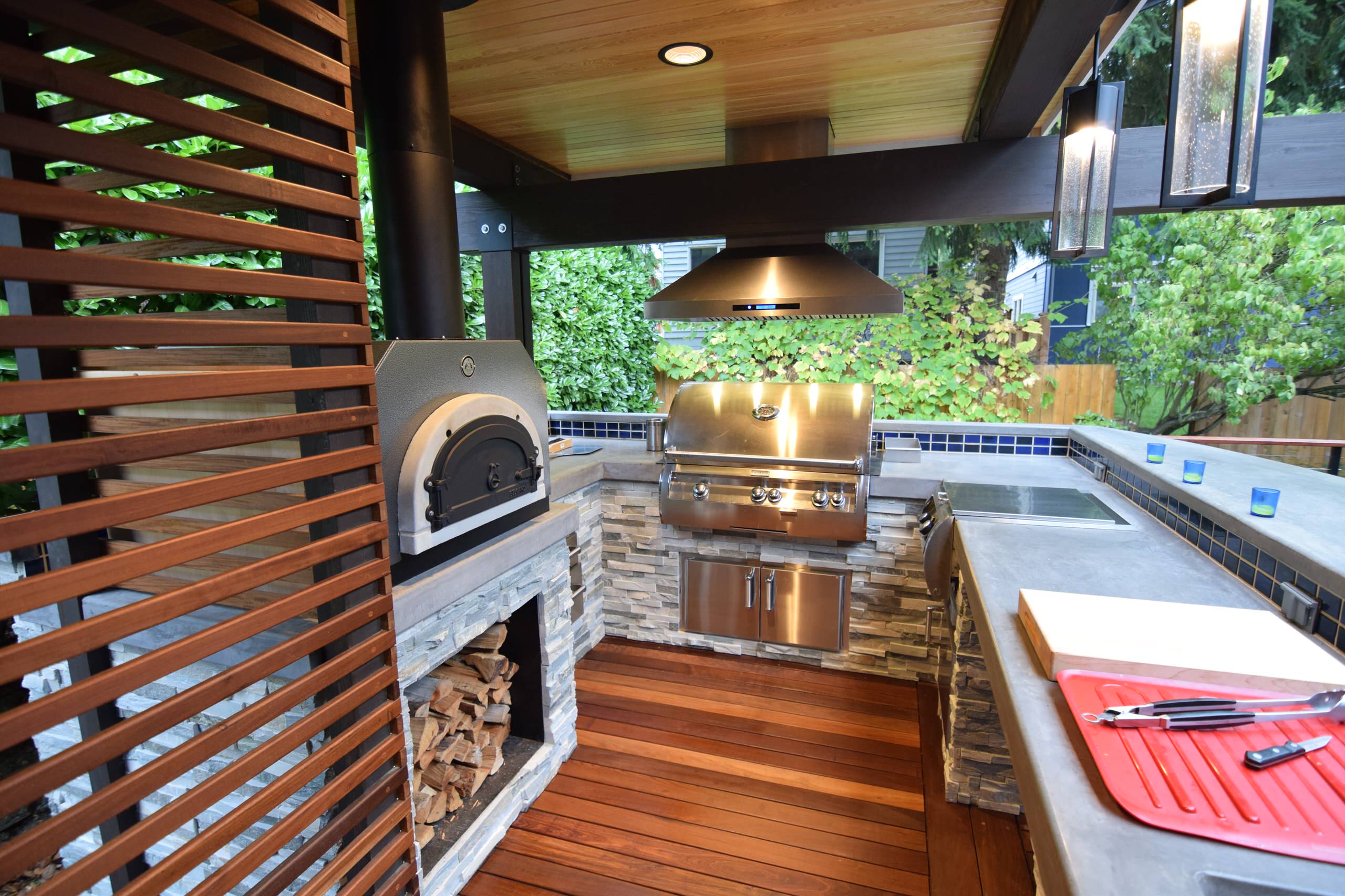 Galley kitchen with pizza oven, grill, cooktop, sink
