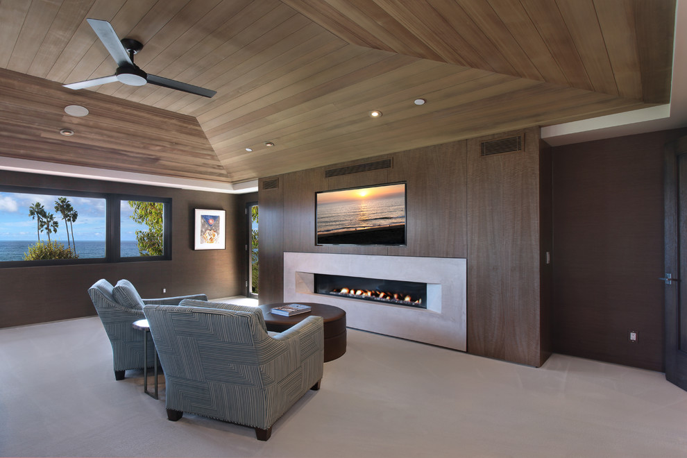 Inspiration for a mid-sized contemporary master bedroom in Orange County with brown walls, carpet, a ribbon fireplace and a concrete fireplace surround.