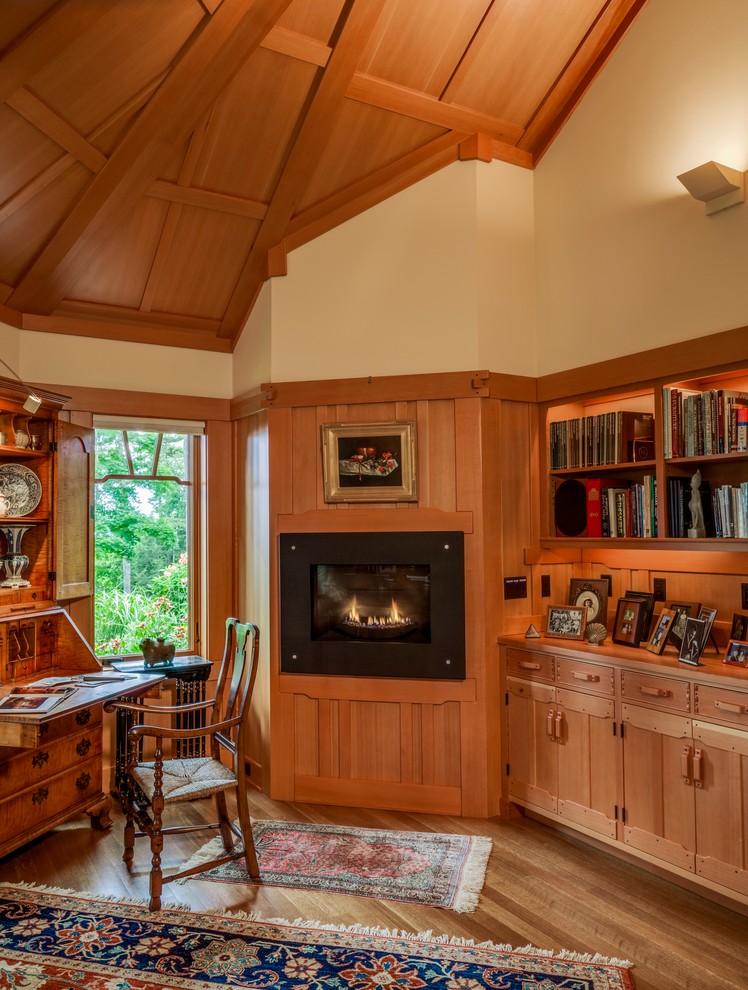 Mid-sized arts and crafts study room in Portland Maine with beige walls, a metal fireplace surround, a freestanding desk, a standard fireplace, light hardwood floors and beige floor.
