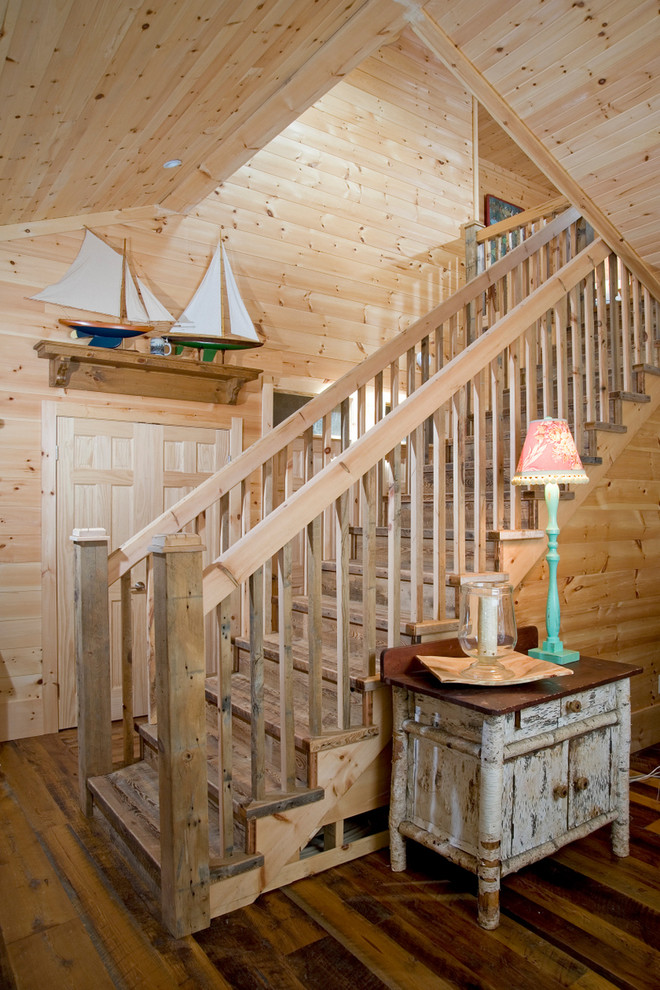 This is an example of a beach style wood straight staircase in Toronto with wood risers and wood railing.