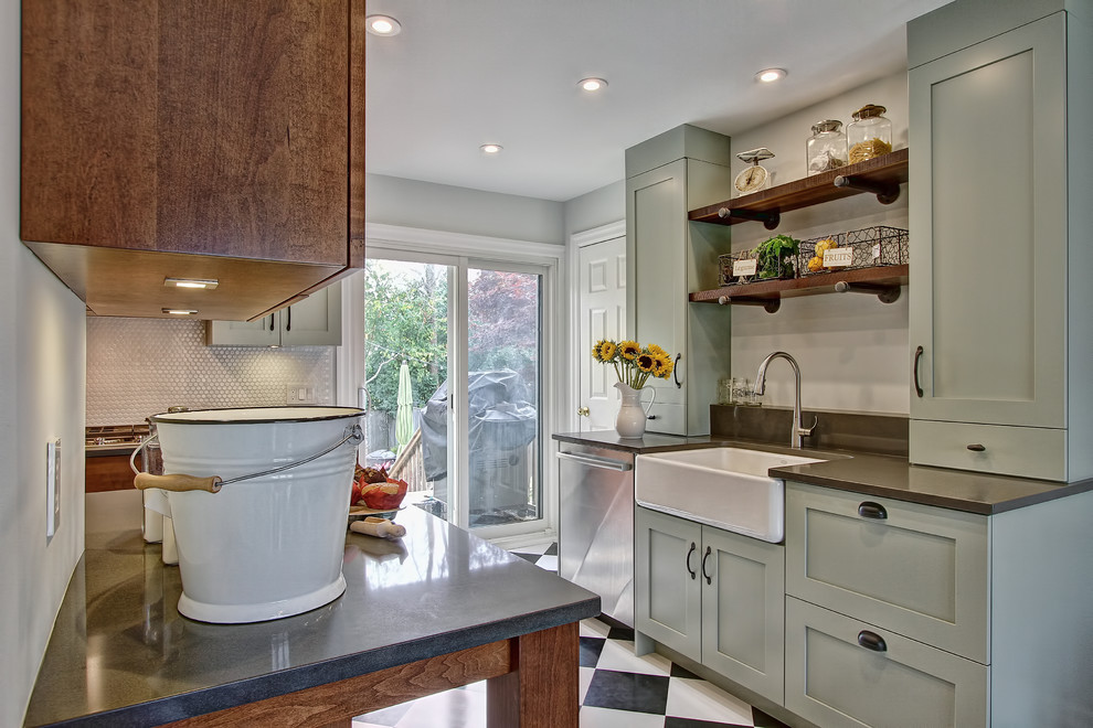 Photo of an eclectic kitchen in Toronto with a farmhouse sink, white splashback, ceramic splashback, stainless steel appliances, recessed-panel cabinets, green cabinets, soapstone benchtops and ceramic floors.