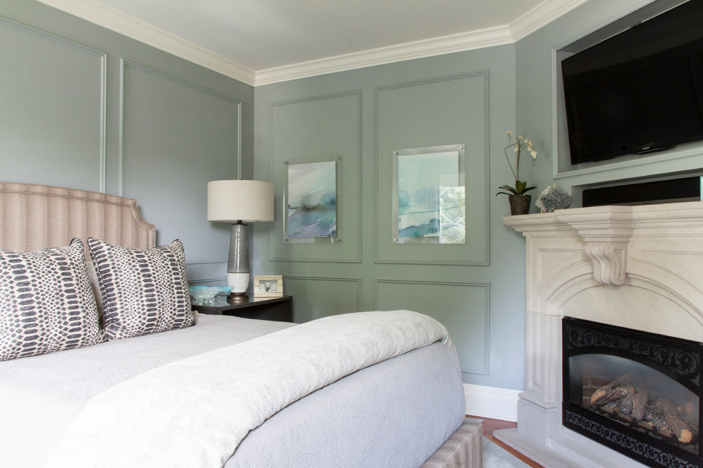 Inspiration for a transitional master bedroom in New York with blue walls, carpet, grey floor, panelled walls, a standard fireplace and a stone fireplace surround.