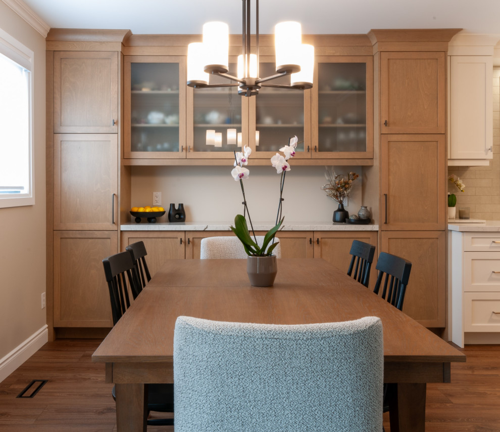 Eat-in kitchen - mid-sized transitional galley laminate floor and brown floor eat-in kitchen idea in Toronto with an undermount sink, recessed-panel cabinets, white cabinets, quartz countertops, beige backsplash, porcelain backsplash, stainless steel appliances and yellow countertops