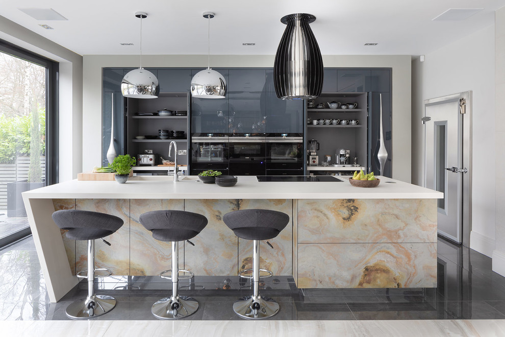 Design ideas for a large contemporary galley kitchen in Hertfordshire with flat-panel cabinets, quartzite benchtops, black appliances, porcelain floors, with island, grey floor, white benchtop, a double-bowl sink and grey cabinets.