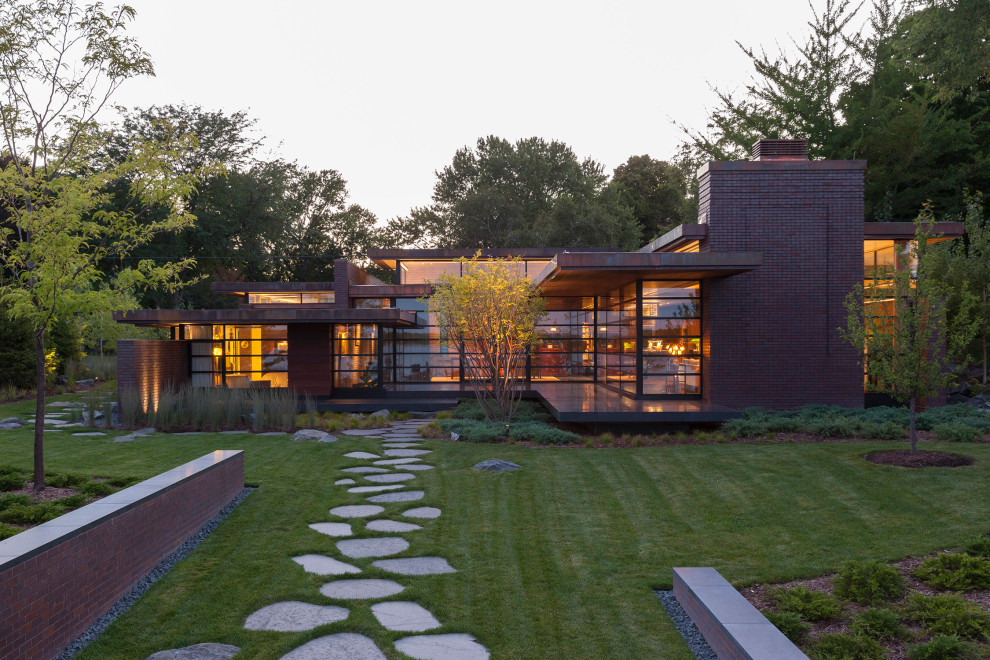 Large modern two-storey brick red house exterior in Milwaukee with a flat roof.