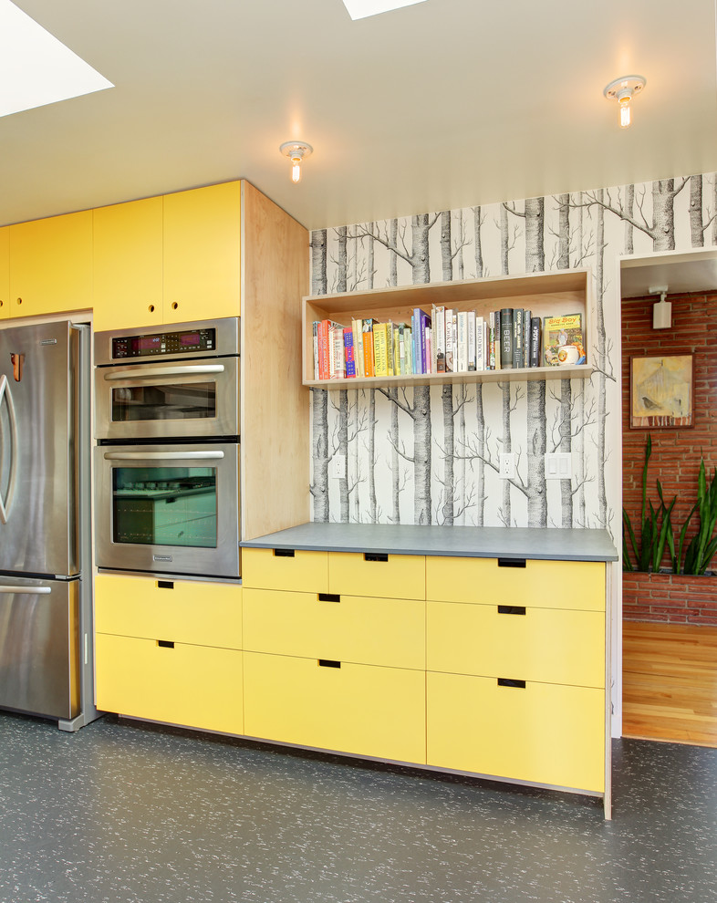Design ideas for a contemporary kitchen in Seattle with flat-panel cabinets, yellow cabinets and stainless steel appliances.