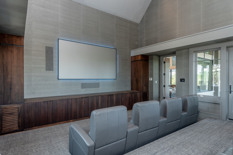 Design ideas for a large contemporary open concept home theatre in Charleston with grey walls, carpet, a wall-mounted tv and grey floor.