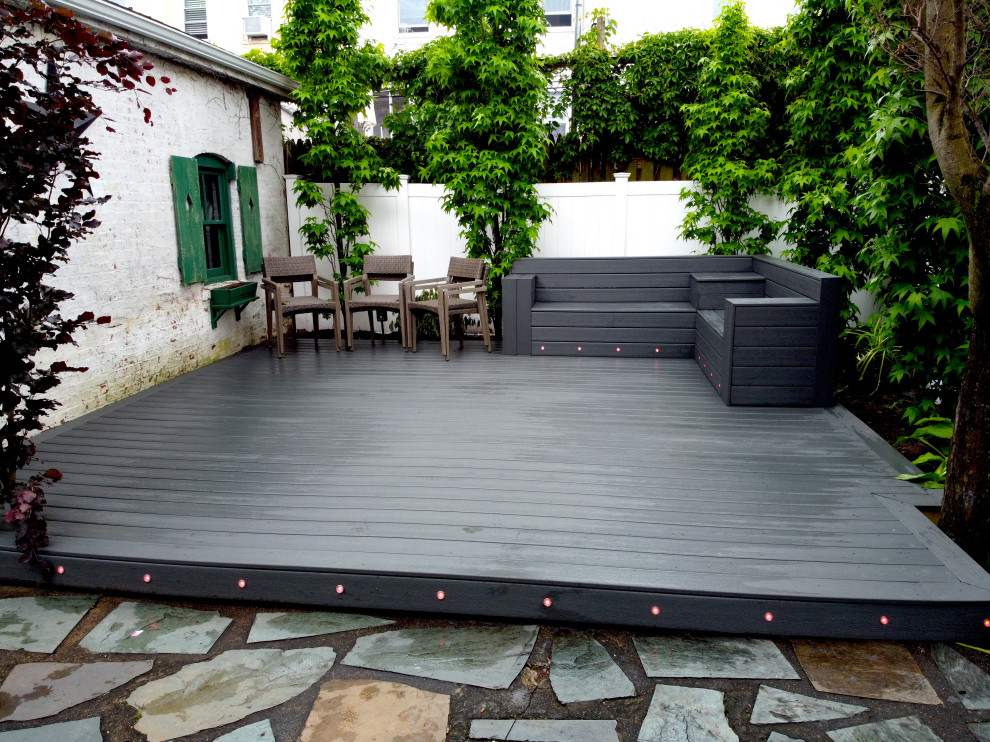 This is an example of a small modern backyard deck in New York.