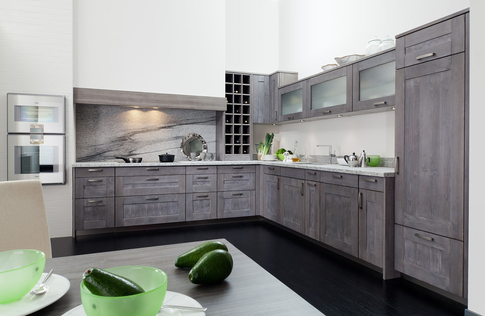 Inspiration for a mid-sized transitional l-shaped dark wood floor enclosed kitchen remodel in Miami with a double-bowl sink, recessed-panel cabinets, medium tone wood cabinets, granite countertops, gray backsplash, stone slab backsplash and stainless steel appliances