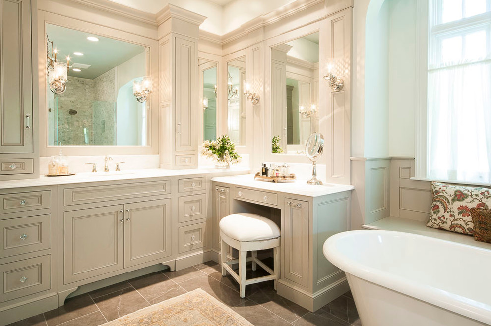 Large traditional master bathroom in St Louis with beaded inset cabinets, white cabinets, a freestanding tub, a curbless shower, a two-piece toilet, gray tile, stone tile, white walls, porcelain floors, an undermount sink and engineered quartz benchtops.