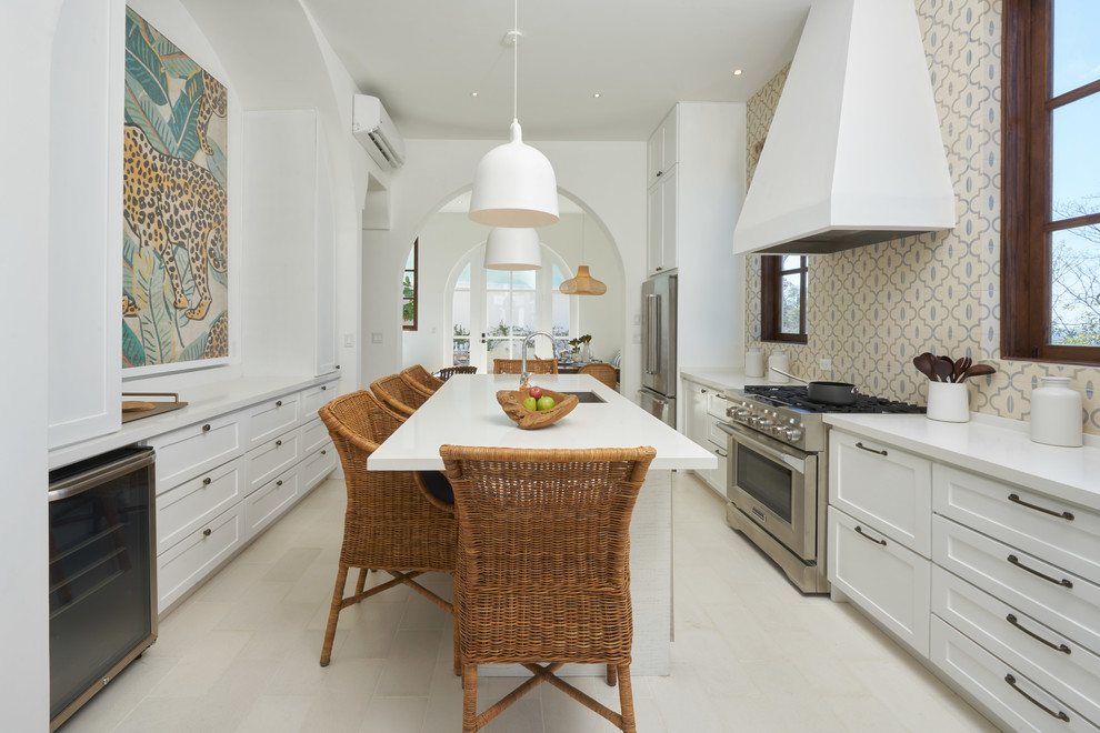 Design ideas for a mid-sized beach style galley eat-in kitchen in Other with an undermount sink, shaker cabinets, white cabinets, quartz benchtops, multi-coloured splashback, cement tile splashback, stainless steel appliances, cement tiles, with island, white floor and white benchtop.