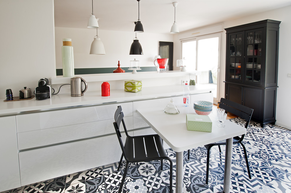 Inspiration for a large contemporary galley eat-in kitchen in Paris with an integrated sink, beaded inset cabinets, white cabinets, solid surface benchtops, cement tiles, white floor and white benchtop.
