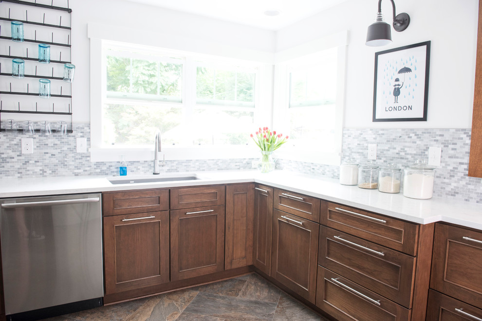 Example of a mid-sized transitional u-shaped vinyl floor and multicolored floor kitchen design with an undermount sink, shaker cabinets, quartz countertops, gray backsplash, marble backsplash, stainless steel appliances, no island, white countertops and medium tone wood cabinets