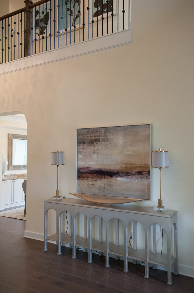 Example of a huge transitional medium tone wood floor foyer design in Jacksonville with beige walls and a metal front door