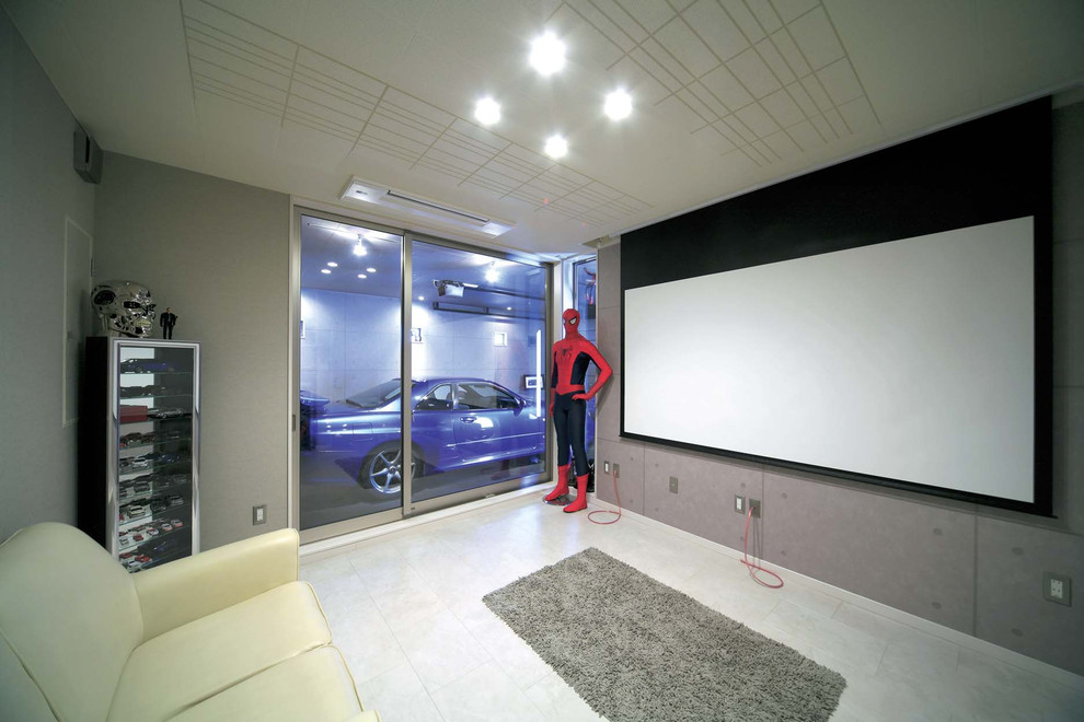 Design ideas for an industrial enclosed home theatre in Other with grey walls, a projector screen and grey floor.