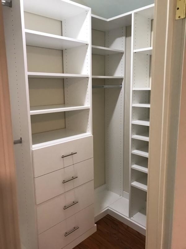 Small transitional gender-neutral walk-in wardrobe in DC Metro with open cabinets.