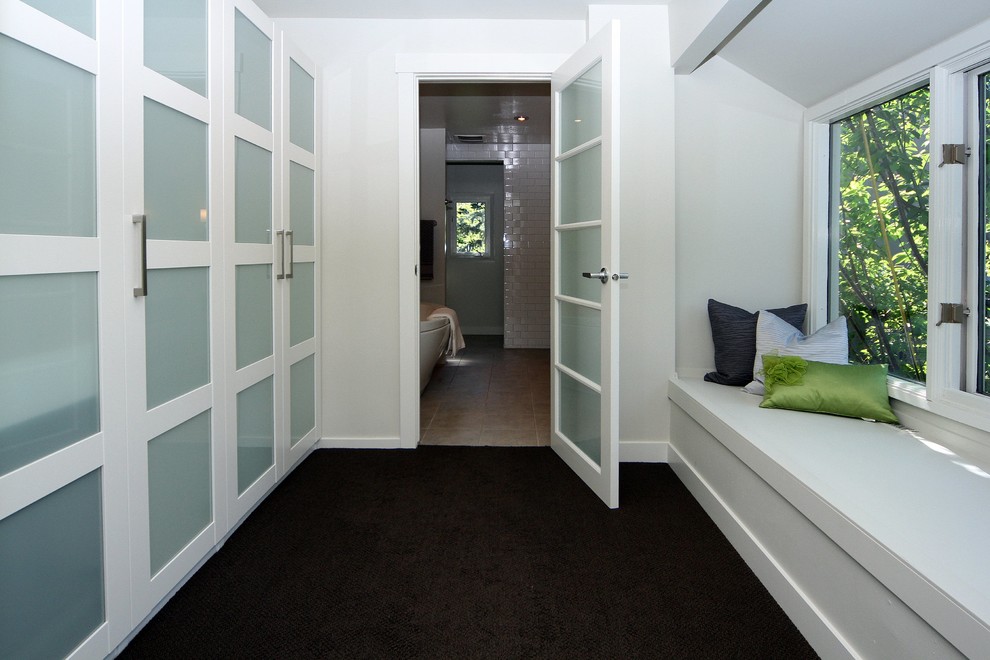 Inspiration for a mid-sized transitional carpeted hallway remodel in Calgary with white walls