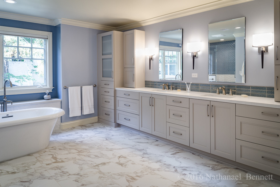 Large transitional master bathroom in San Francisco with shaker cabinets, white cabinets, a freestanding tub, an alcove shower, a two-piece toilet, blue tile, glass tile, blue walls, marble floors, an integrated sink and solid surface benchtops.