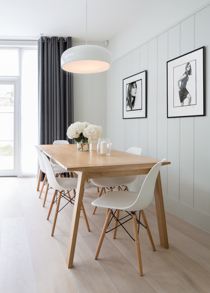 Design ideas for an expansive classic open plan dining room in London with light hardwood flooring and brown floors.