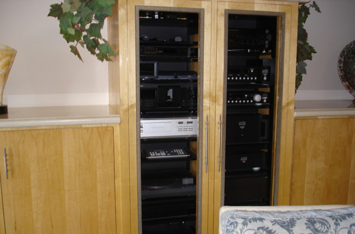 Inspiration for a living room remodel in Phoenix with white walls and a media wall