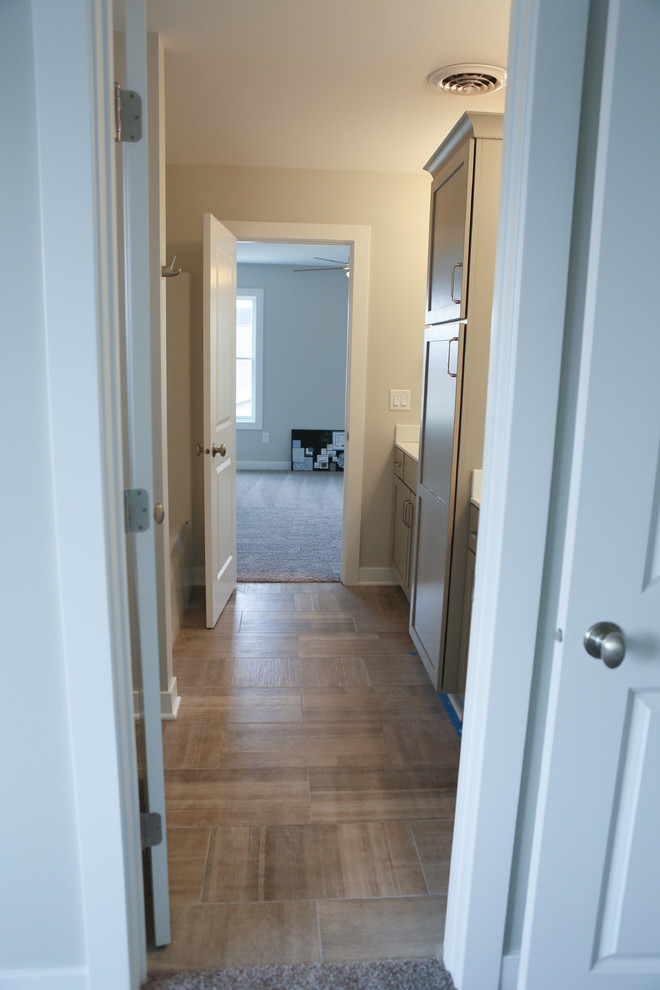 Inspiration for a mid-sized transitional master beige tile and porcelain tile porcelain tile home design remodel in Chicago with shaker cabinets, gray cabinets, a two-piece toilet, gray walls, a drop-in sink and marble countertops