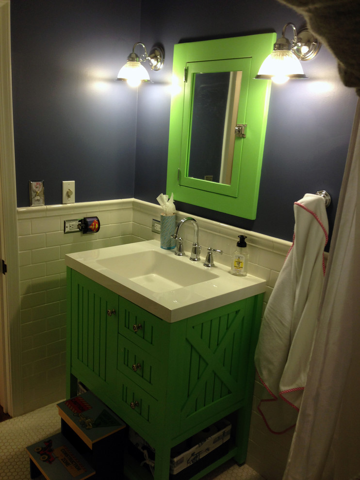This is an example of a small country kids bathroom in Chicago with green cabinets, an alcove tub, a shower/bathtub combo, white tile, porcelain tile, blue walls and mosaic tile floors.