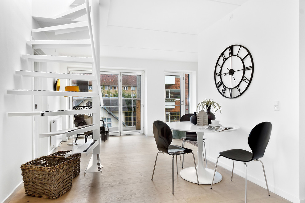 Photo of a small scandinavian open plan dining in Copenhagen with white walls, light hardwood floors and no fireplace.
