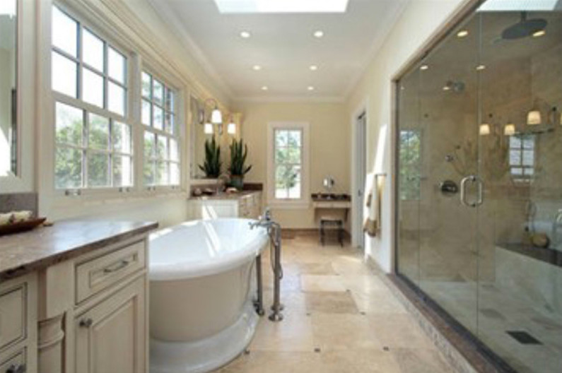 Large transitional master beige tile and stone slab ceramic tile freestanding bathtub photo in Denver with raised-panel cabinets, beige cabinets, yellow walls and solid surface countertops