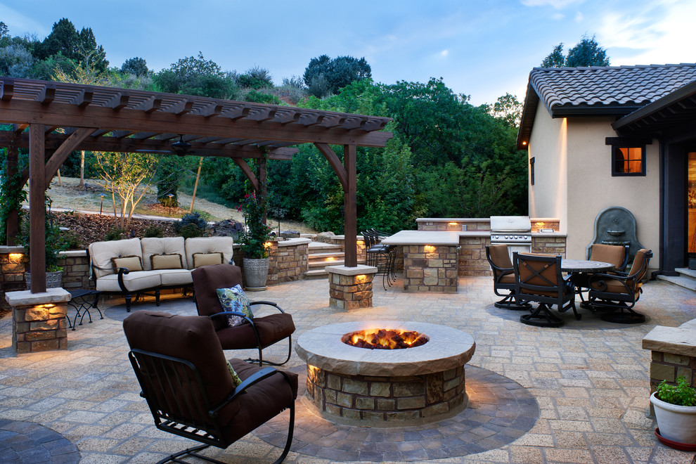 Patio - mid-sized contemporary backyard stone patio idea in Denver with a fire pit and a pergola