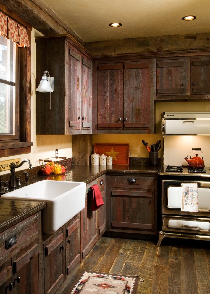 Inspiration for a country l-shaped kitchen in Bridgeport with a farmhouse sink, distressed cabinets and dark hardwood floors.