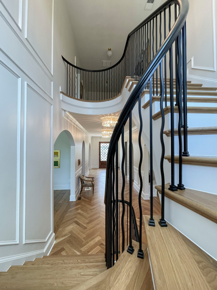 Inspiration for a large transitional wooden floating mixed material railing and wainscoting staircase remodel in DC Metro with painted risers