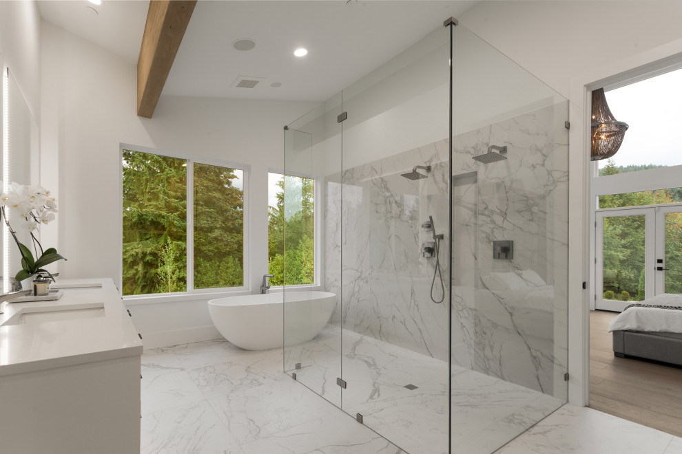 Large modern master bathroom in Seattle with white cabinets, a freestanding tub, a curbless shower, a one-piece toilet, white tile, stone slab, white walls, ceramic floors, an undermount sink, engineered quartz benchtops, white floor, an open shower, white benchtops, flat-panel cabinets and a floating vanity.